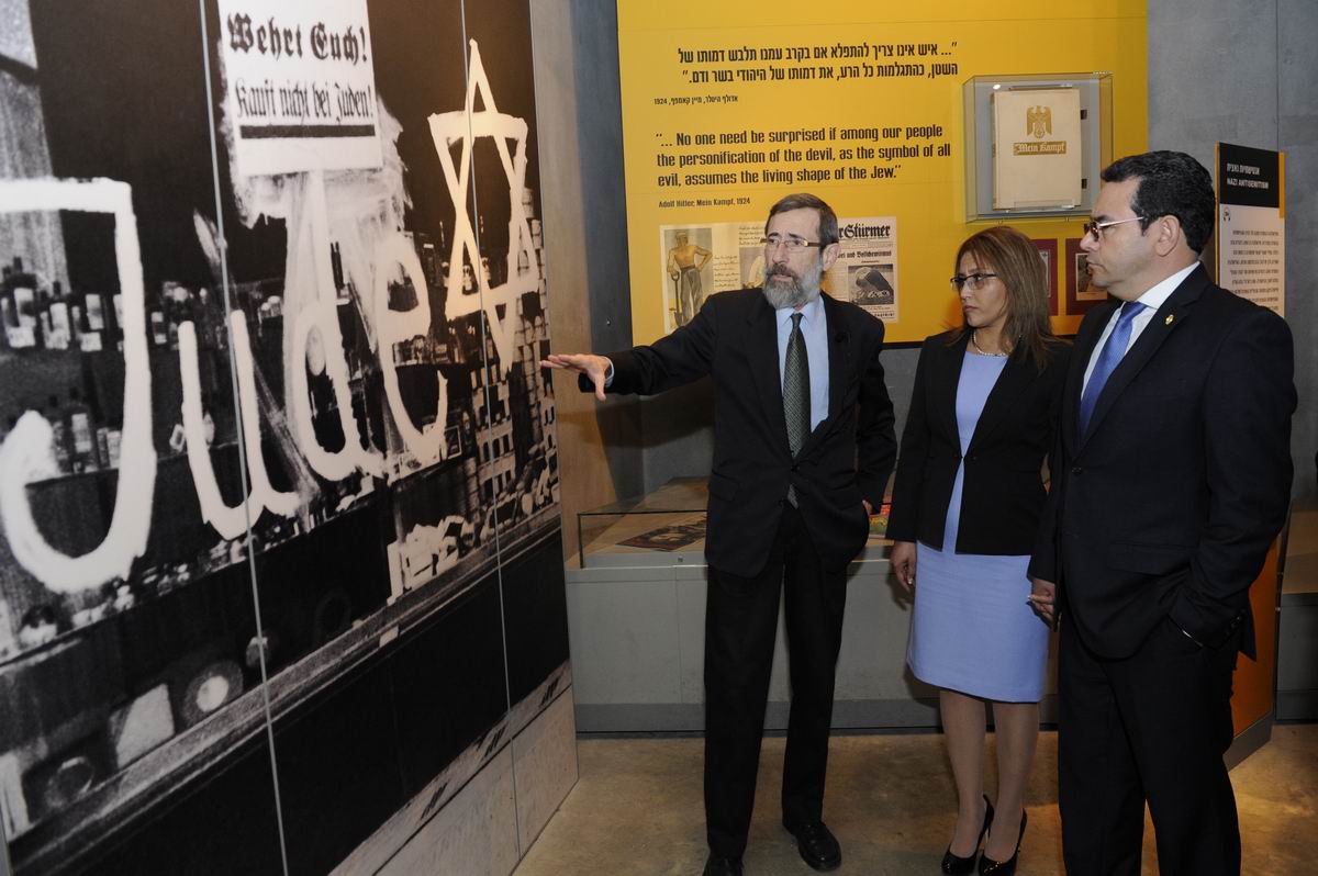 Director of the Hall of Names Dr. Alexander Avram (left) guided the President and his wife through the Holocaust History Museum